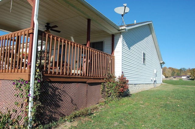 view of property exterior featuring ceiling fan and a yard