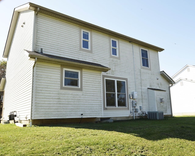 rear view of house with a yard