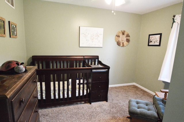 bedroom with light carpet and a nursery area