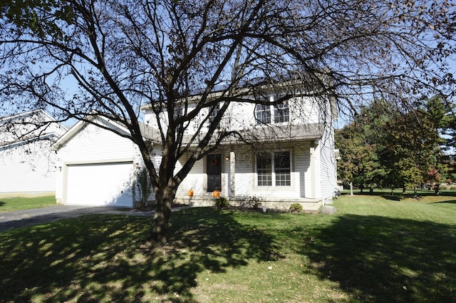 view of front of house with a front yard and a garage