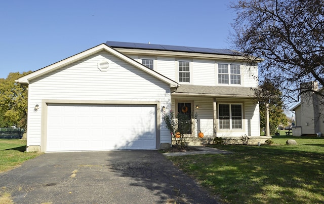 view of property with covered porch, a front lawn, a garage, and solar panels