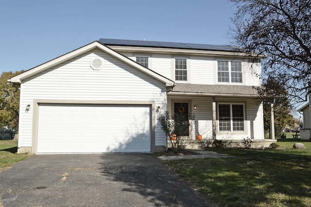 front of property with a front yard, solar panels, a porch, and a garage