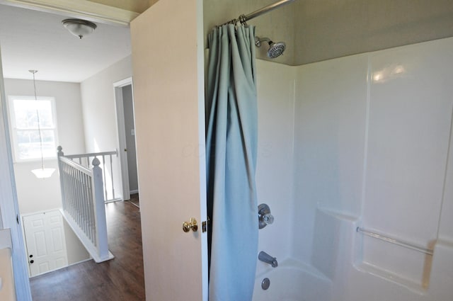 bathroom featuring hardwood / wood-style floors and shower / bath combination with curtain