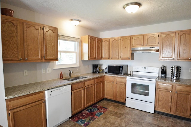 kitchen featuring a textured ceiling, white appliances, and sink