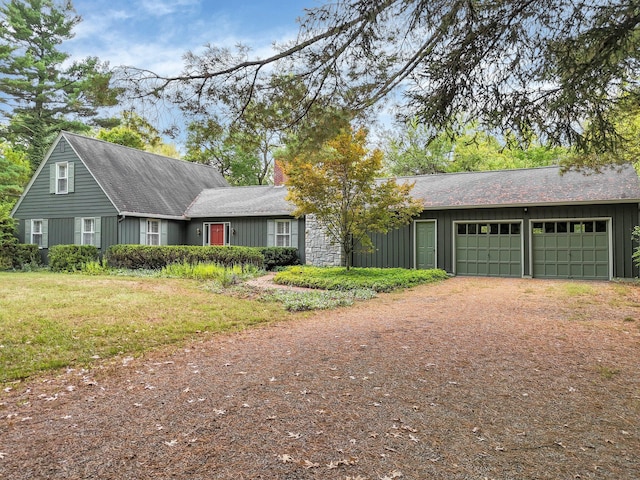 single story home with a garage and a front yard