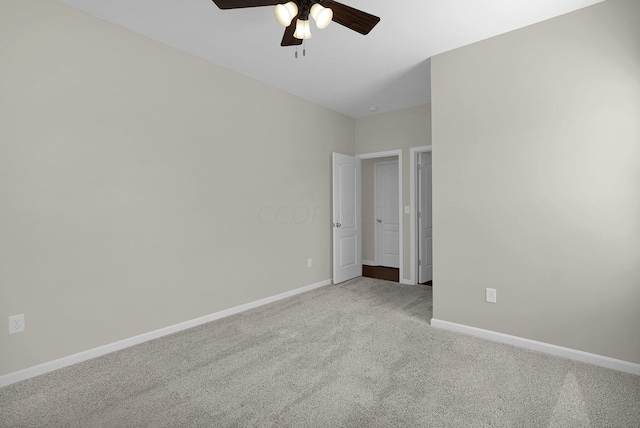 carpeted spare room featuring ceiling fan