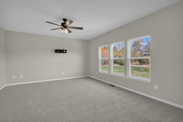 carpeted spare room with ceiling fan