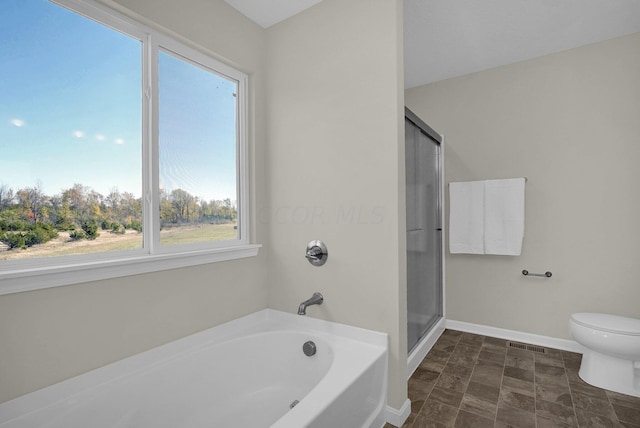 bathroom with separate shower and tub and toilet