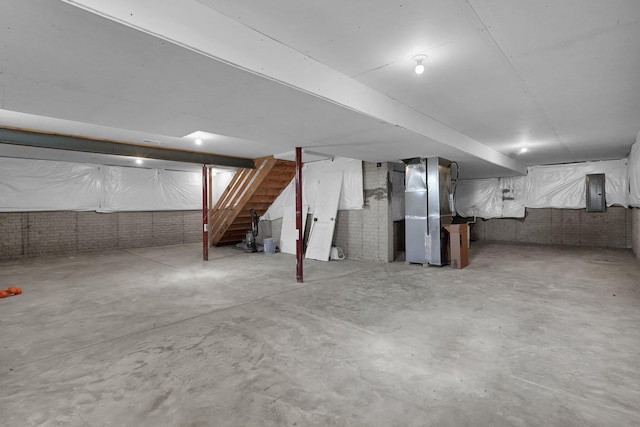 basement with electric panel and heating unit