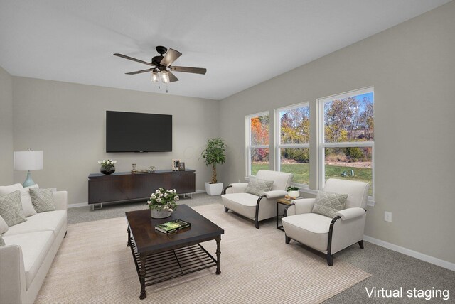 carpeted living room with ceiling fan