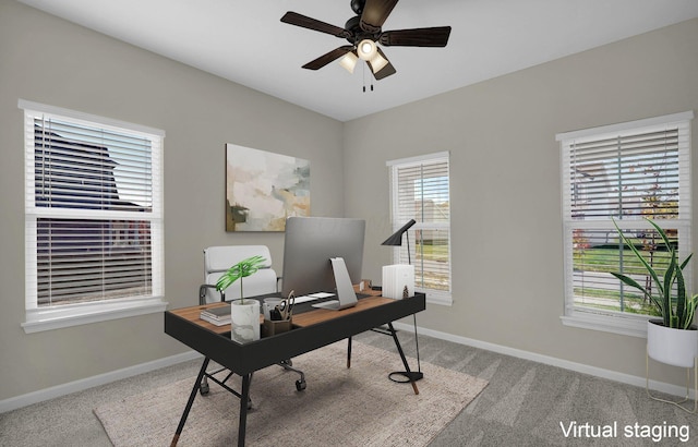 office space with ceiling fan and light carpet