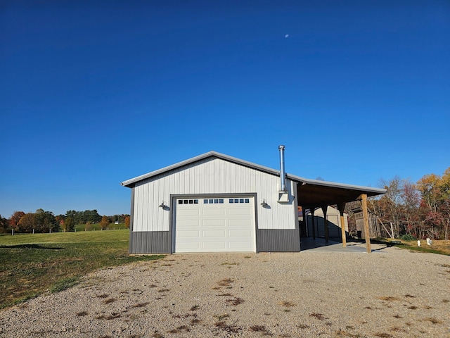 garage with a garage and gravel driveway