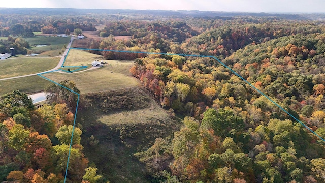 drone / aerial view featuring a wooded view