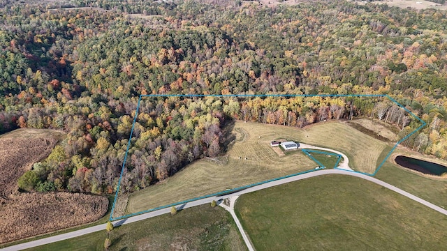 birds eye view of property featuring a wooded view