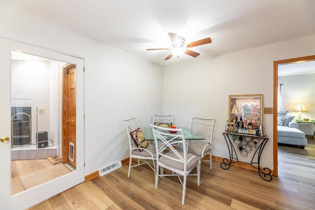 dining space featuring ceiling fan and wood-type flooring