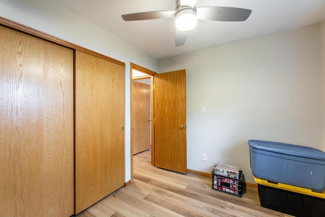 interior space with ceiling fan, light hardwood / wood-style flooring, and a closet