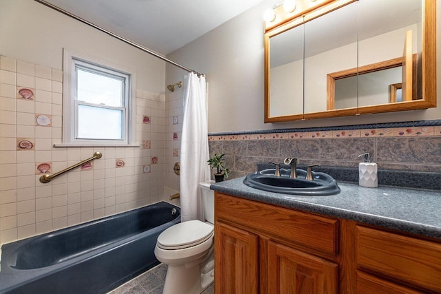 full bathroom featuring shower / bath combo, vanity, tile walls, tile patterned flooring, and toilet