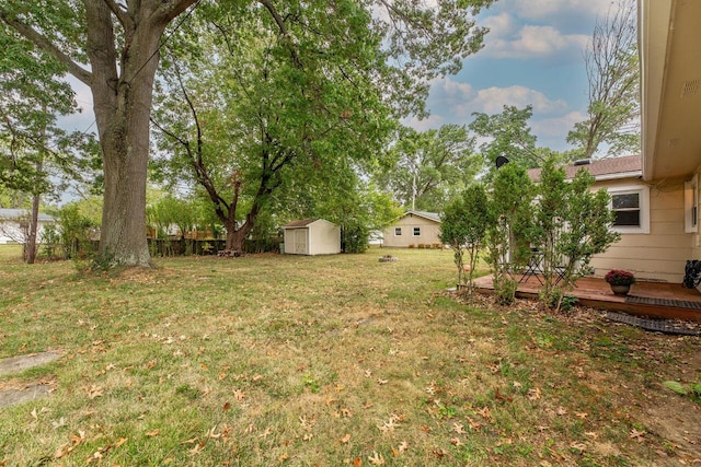 view of yard featuring a deck and a storage unit