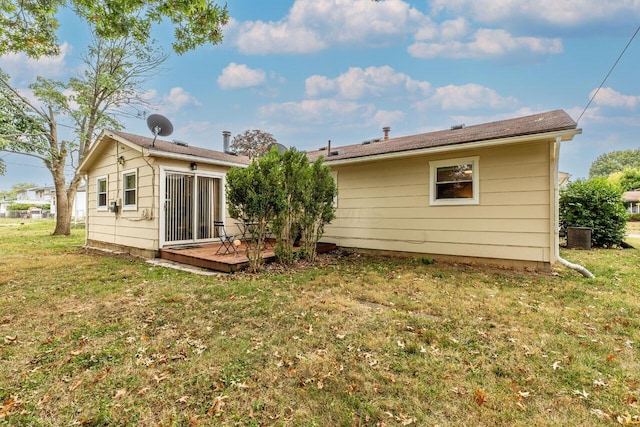 rear view of property with a yard and a wooden deck