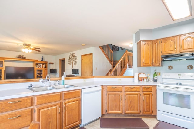 kitchen featuring kitchen peninsula, ceiling fan, white appliances, and sink