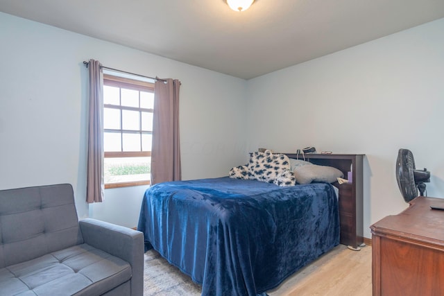 bedroom featuring light hardwood / wood-style floors and multiple windows