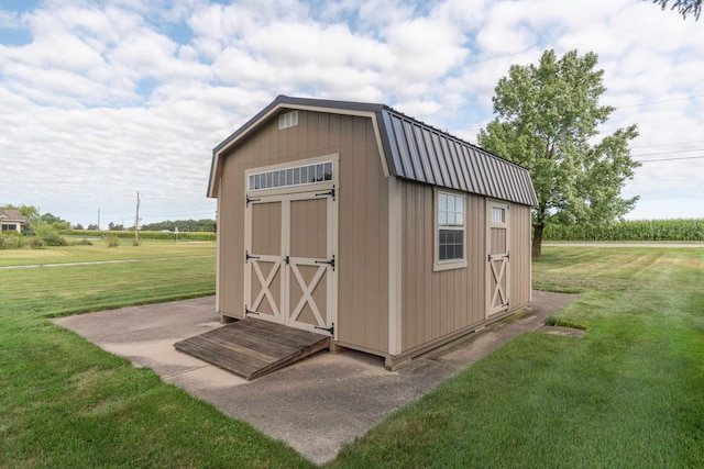 view of outbuilding featuring a yard