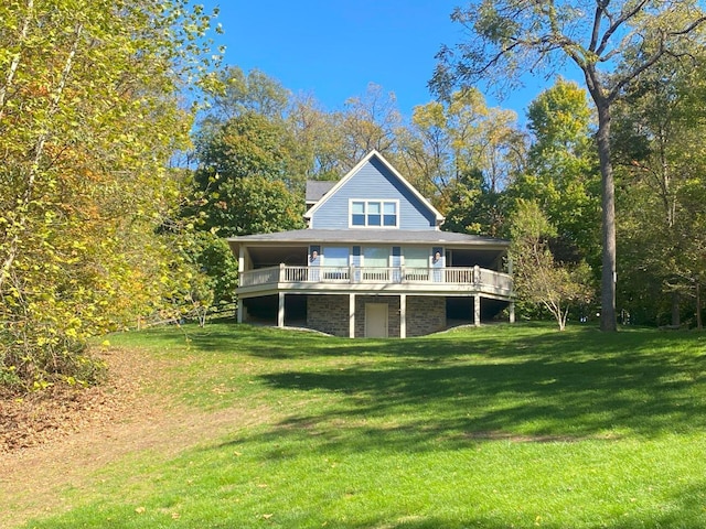 back of house with a wooden deck and a yard