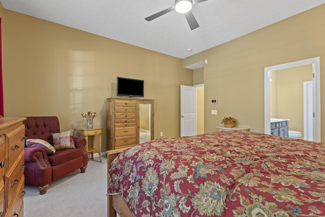 carpeted bedroom with connected bathroom and ceiling fan