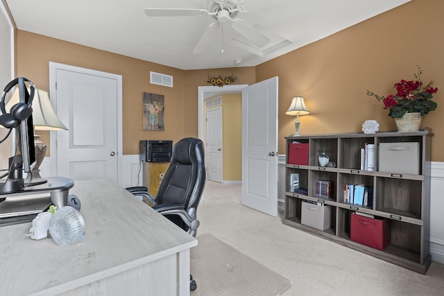 carpeted office with ceiling fan