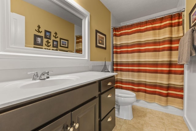 bathroom featuring tile patterned flooring, vanity, a textured ceiling, and toilet