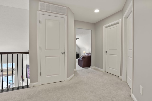 corridor with light colored carpet