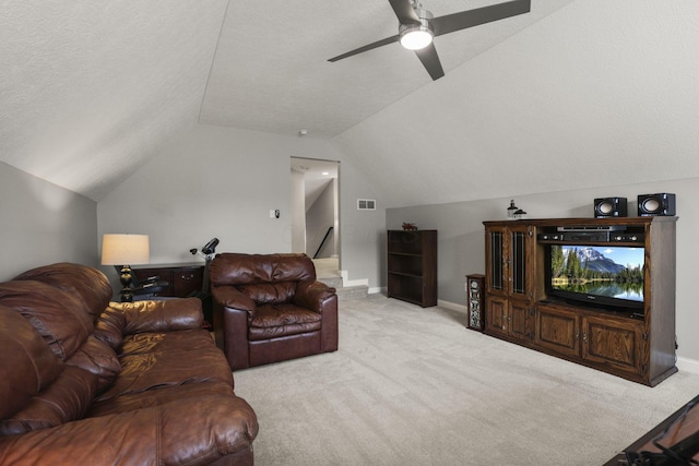 carpeted living room featuring ceiling fan, a textured ceiling, and vaulted ceiling