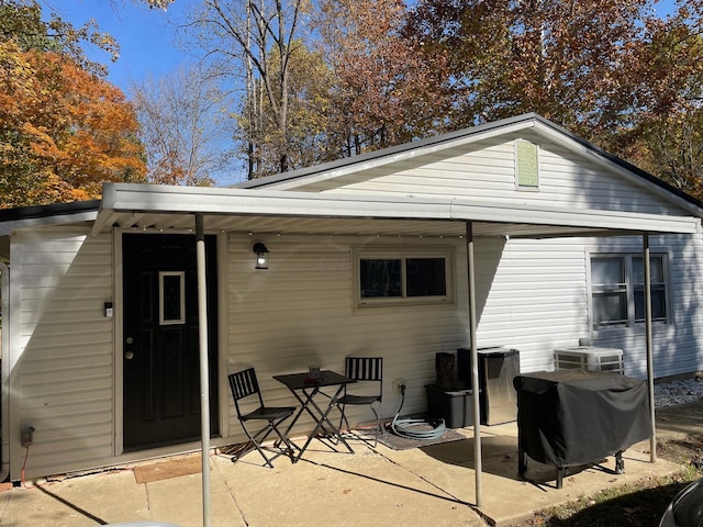 back of property with cooling unit and a patio area