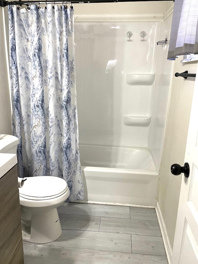 full bathroom with toilet, vanity, shower / bath combination with curtain, and hardwood / wood-style floors