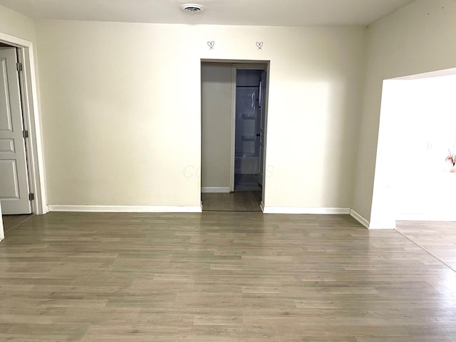 unfurnished room featuring hardwood / wood-style floors