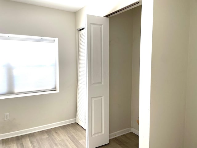 unfurnished bedroom featuring a closet and light hardwood / wood-style floors