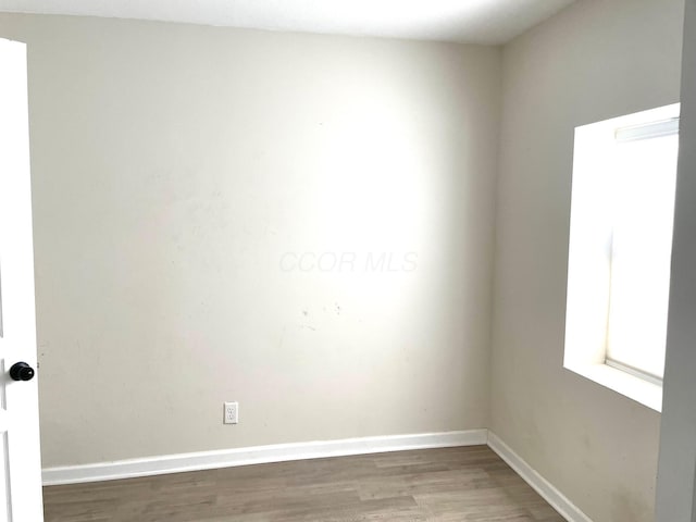 spare room with hardwood / wood-style floors