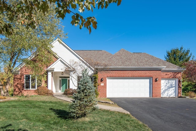 view of front of house with a garage and a front lawn