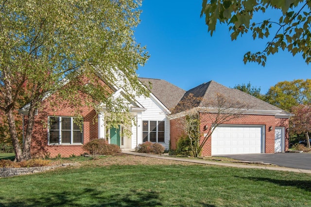 view of front of property with a front yard and a garage