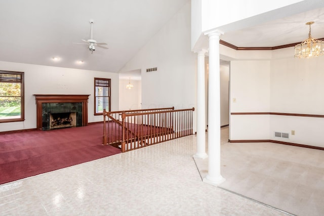 unfurnished living room featuring carpet, ceiling fan with notable chandelier, a premium fireplace, and high vaulted ceiling