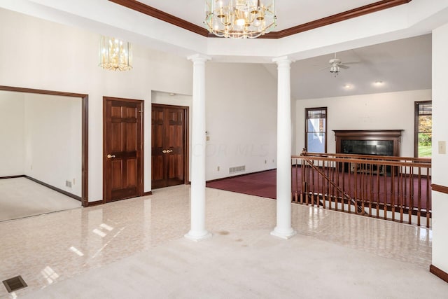 carpeted living room with ceiling fan with notable chandelier, a wealth of natural light, and ornamental molding