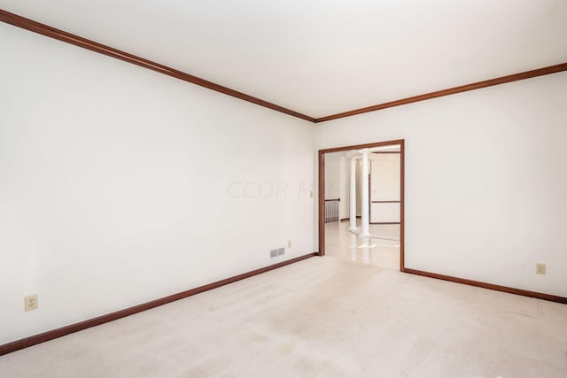 carpeted empty room featuring crown molding