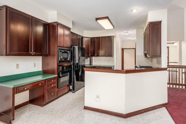 kitchen featuring decorative backsplash, sink, and black appliances