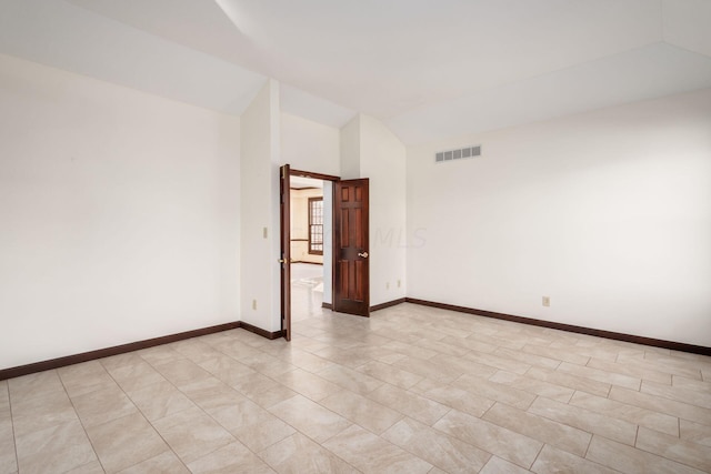 spare room with lofted ceiling