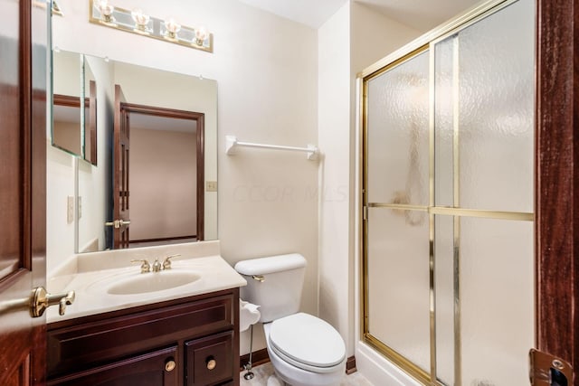 bathroom featuring vanity, toilet, and walk in shower