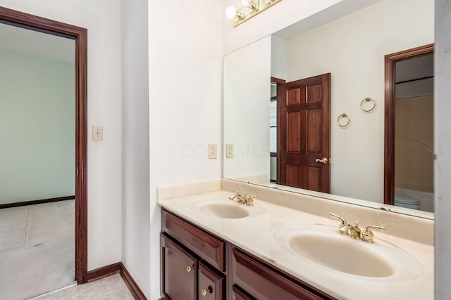 bathroom featuring tile patterned floors, vanity, and toilet