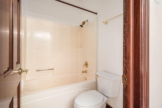 bathroom featuring shower / tub combination and toilet