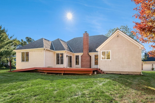 rear view of house featuring a lawn and a wooden deck