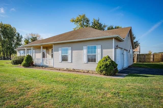 view of front of house featuring a front yard, a porch, and a garage