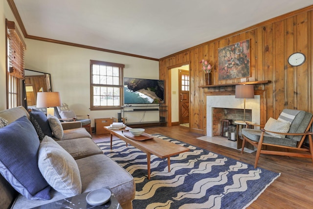 living room with wood-type flooring, ornamental molding, and wood walls